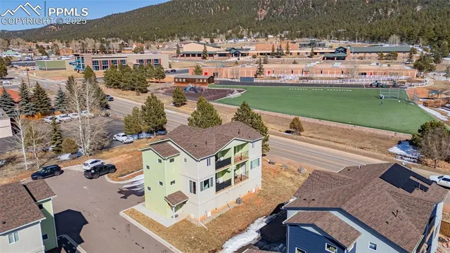 an aerial view of a house with a yard