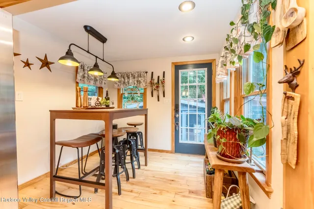 a view of a dining room with furniture window and wooden floor