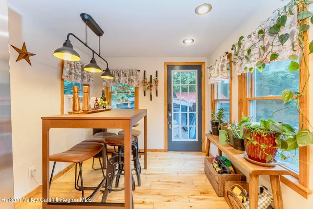 a dining room with furniture and a floor to ceiling window