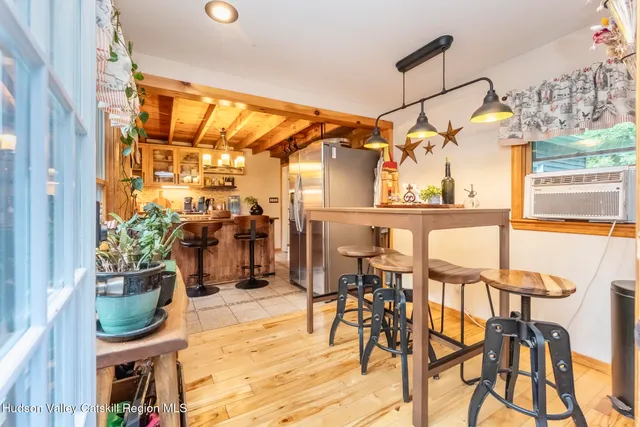 a dining room with furniture and a window