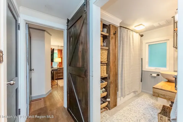 a view of a bathroom with tub and door