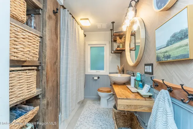 a bathroom with a toilet sink and mirror