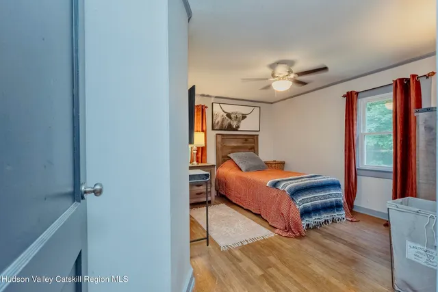 a bedroom with bed and a chandelier
