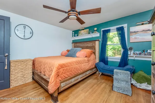 a bed sitting in a bedroom next to a window