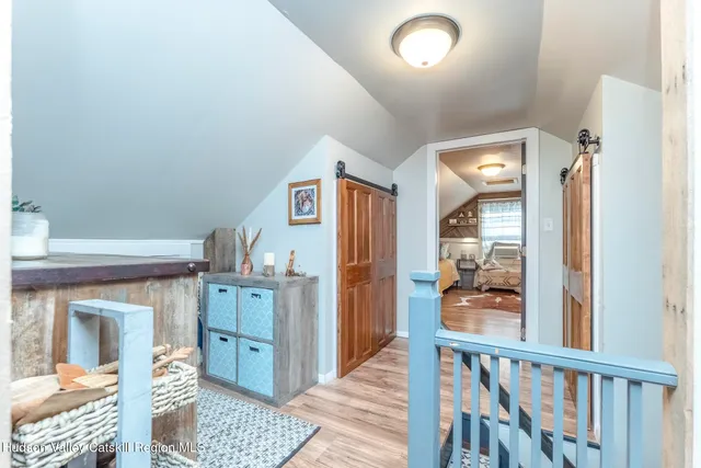 a view of a hallway to a livingroom with furniture
