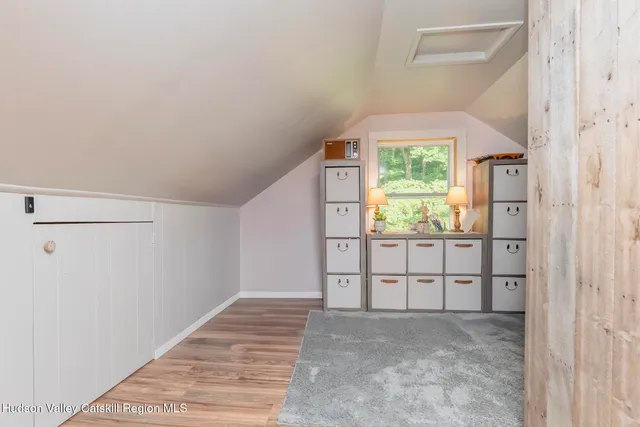 a hallway with a large window and wooden floor