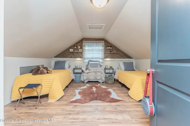 a bed room with a bed mirror table and chair