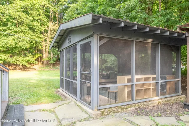 a living room with furniture tv and a large window