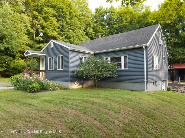 a house that has a big yard with large trees