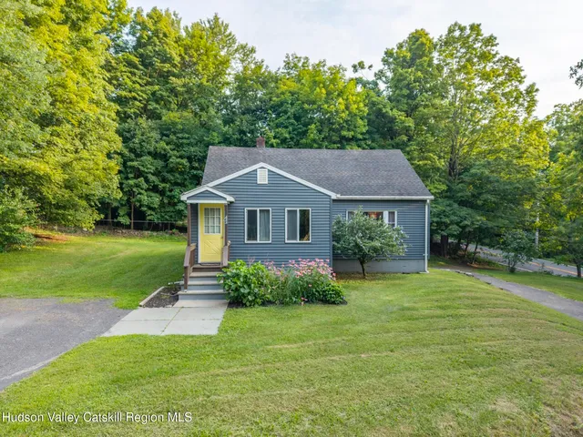 a backyard of a house with table and chairs