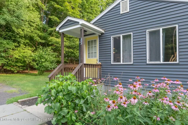 a view of a house with backyard and deck