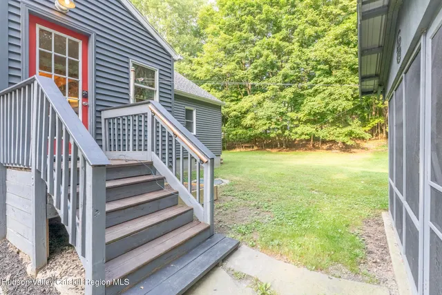 a view of a house with backyard and porch