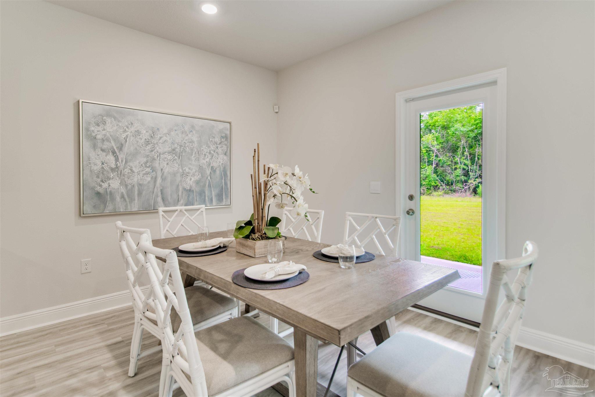 4753 Redhead Court Pace, FL 32571 - Photo 19 of 44 a view of a dining room with furniture and a window