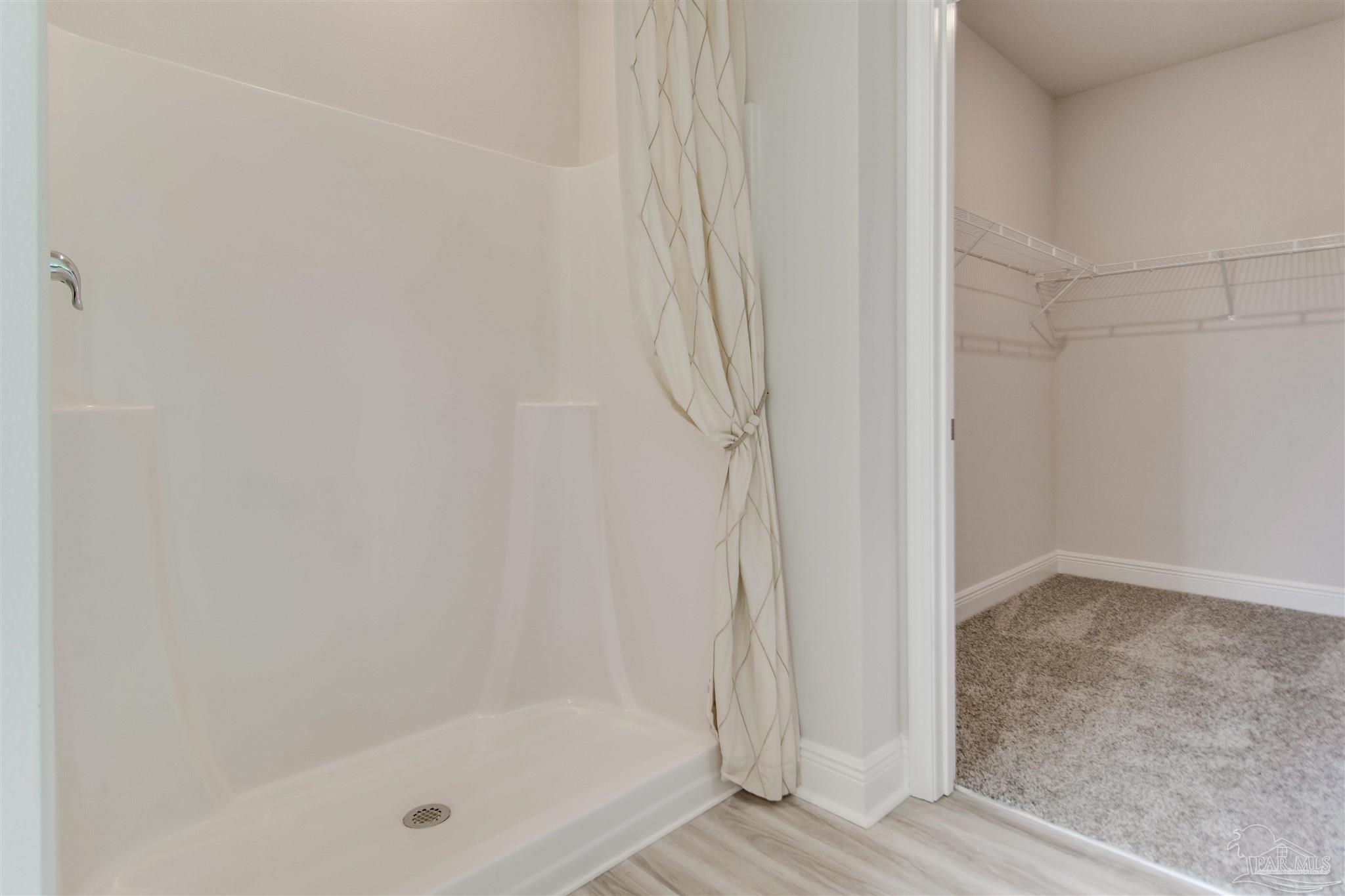 4753 Redhead Court Pace, FL 32571 - Photo 29 of 44 a bathroom with a glass shower door