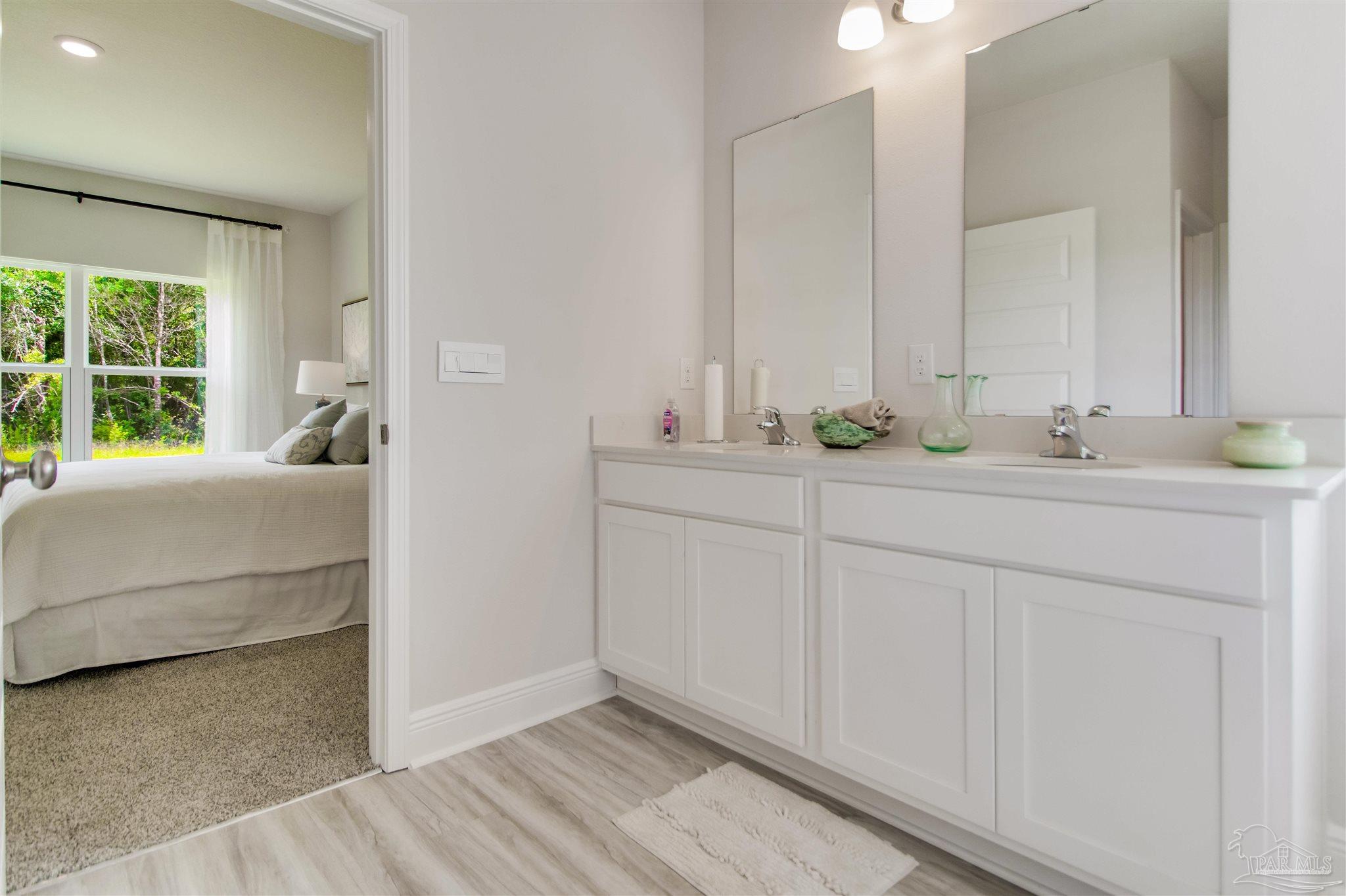 4753 Redhead Court Pace, FL 32571 - Photo 31 of 44 a en suite bathroom with 2 sink and a mirror