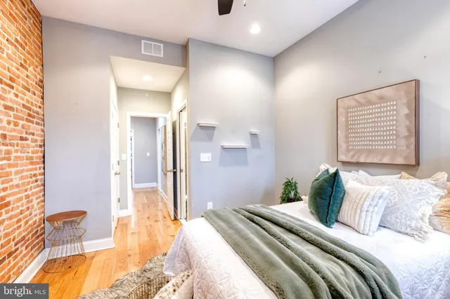 a bedroom with a bed and a large mirror