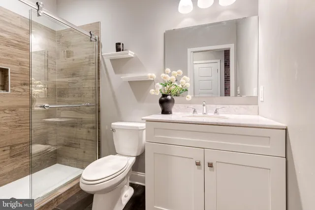 a bathroom with a sink toilet and shower