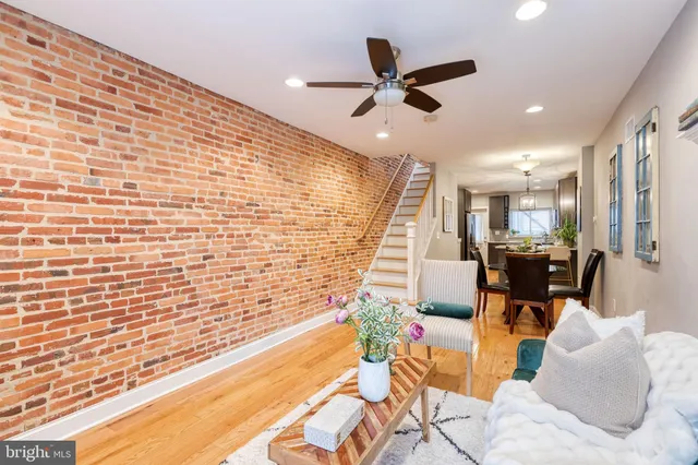 a living room with fireplace furniture and a wooden floor