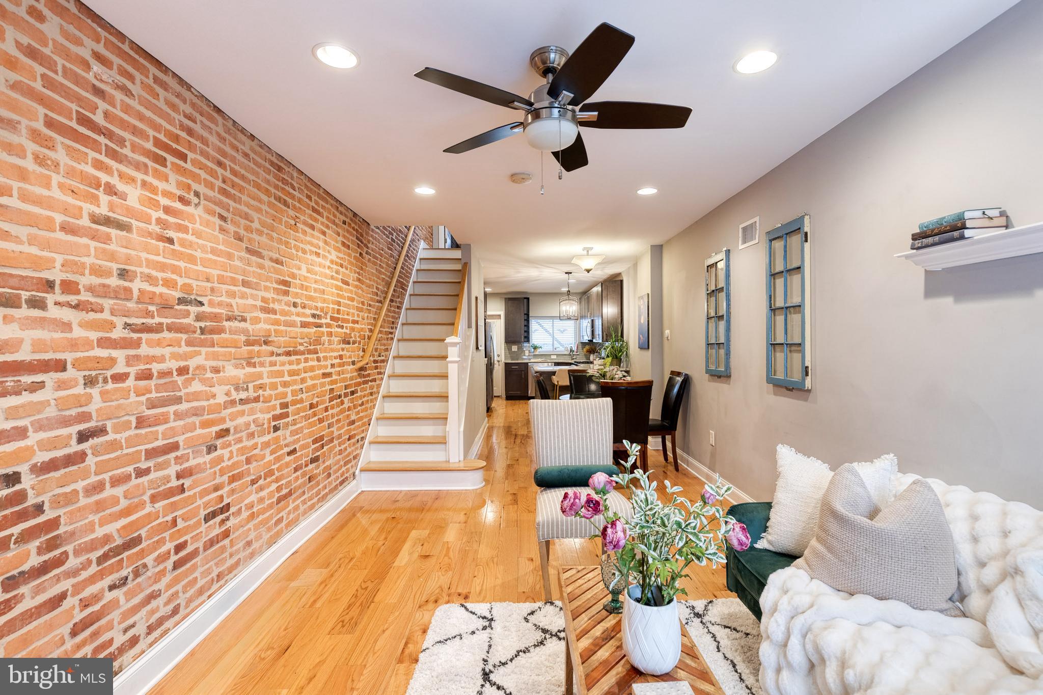 626 South Curley Street Baltimore, MD 21224 - Photo 4 of 23 a living room with couches and kitchen view with wooden floor