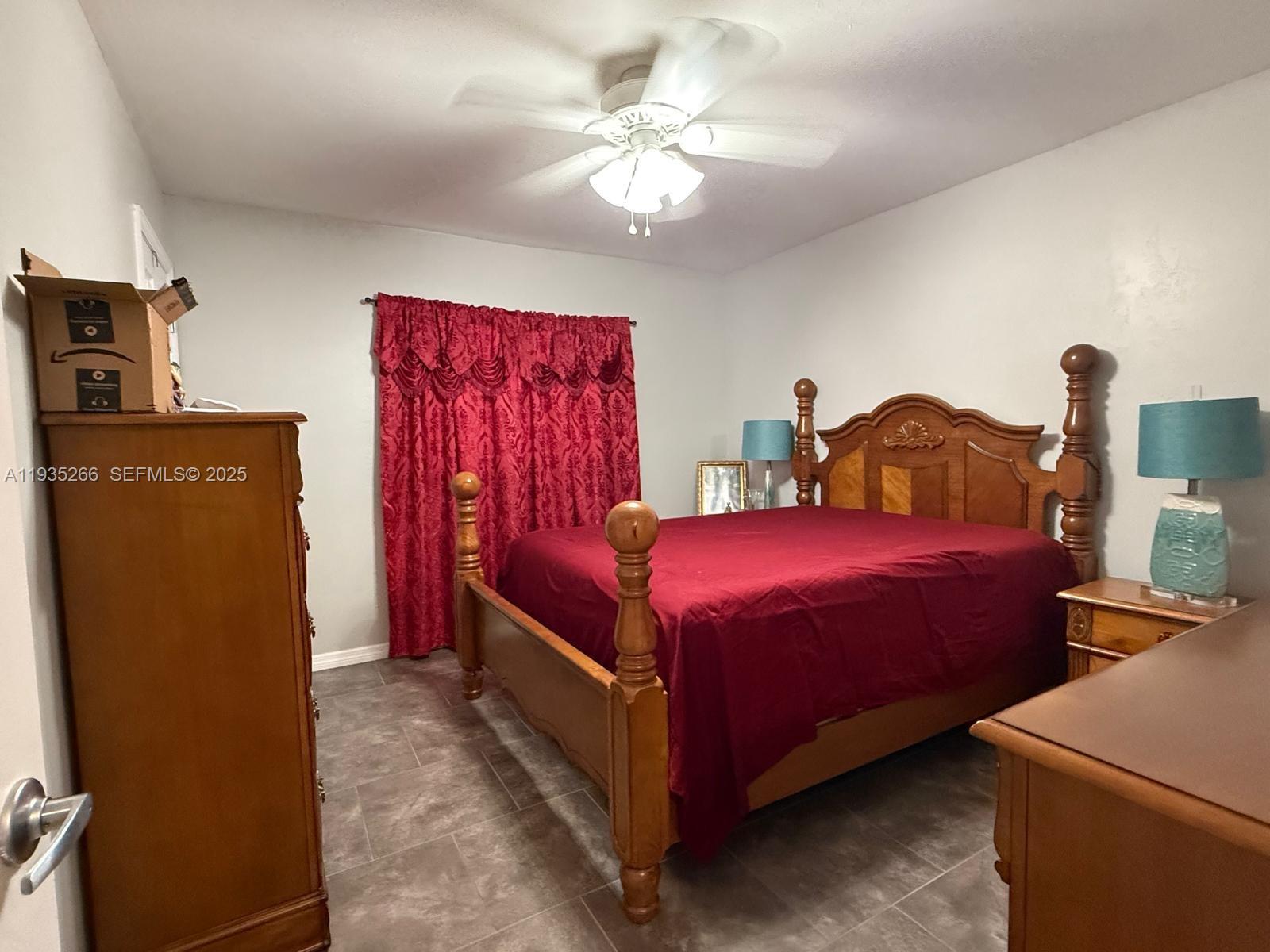 1046 Bayberry Loop Clewiston, FL 33440 - Photo 15 of 32 a bedroom with bed and a chandelier