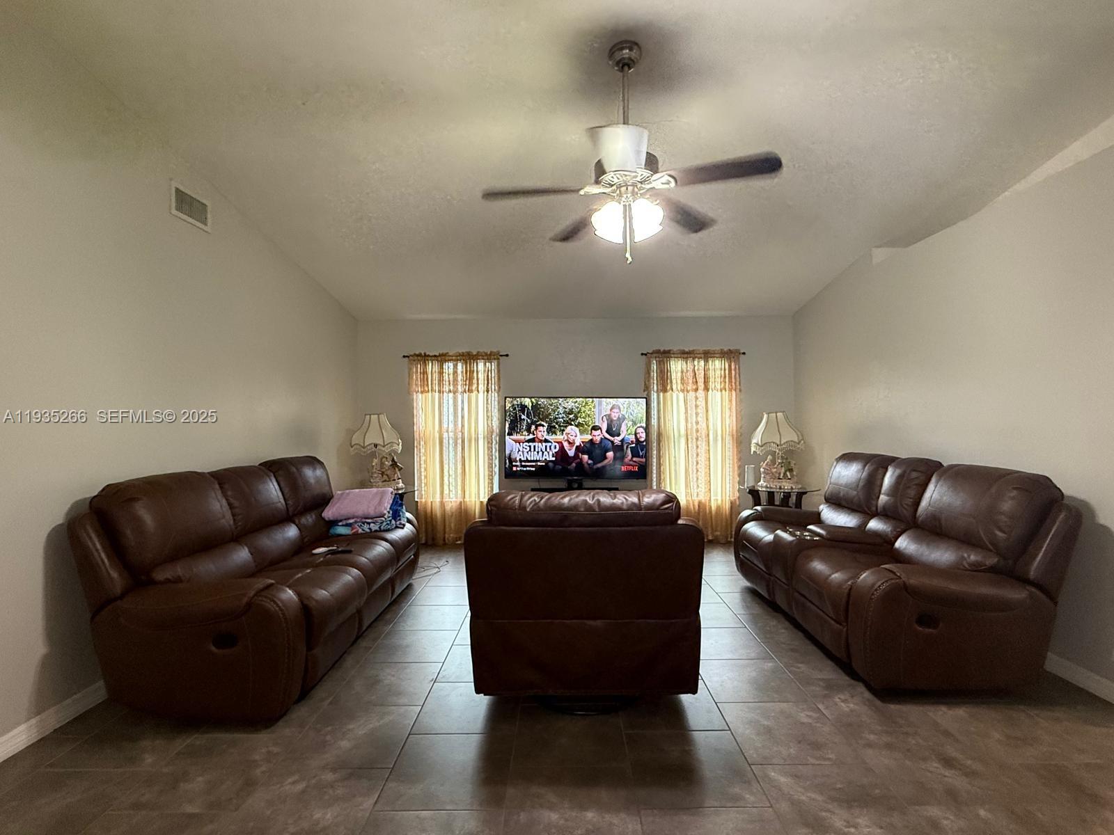 1046 Bayberry Loop Clewiston, FL 33440 - Photo 2 of 32 a living room with furniture and a flat screen tv