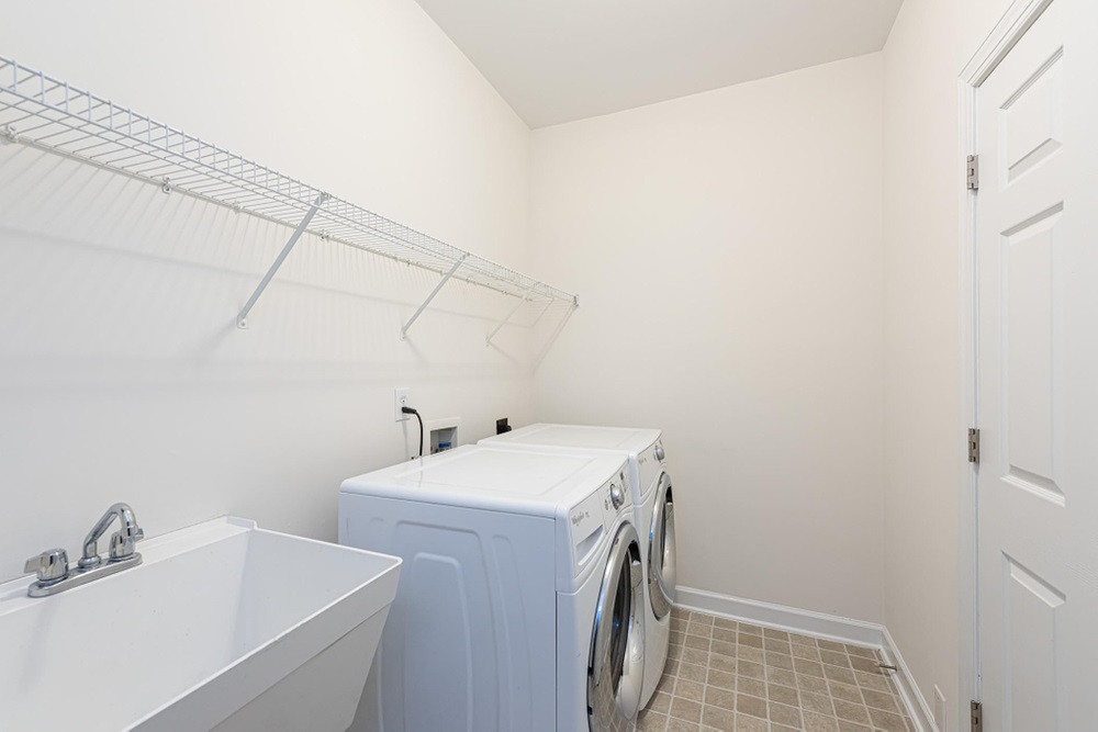 3105 Hummer Way Raleigh, NC 27614 - Photo 15 of 30 Laundry Room on main floor with wire shelving overhead and a utility sink. Laundry Room