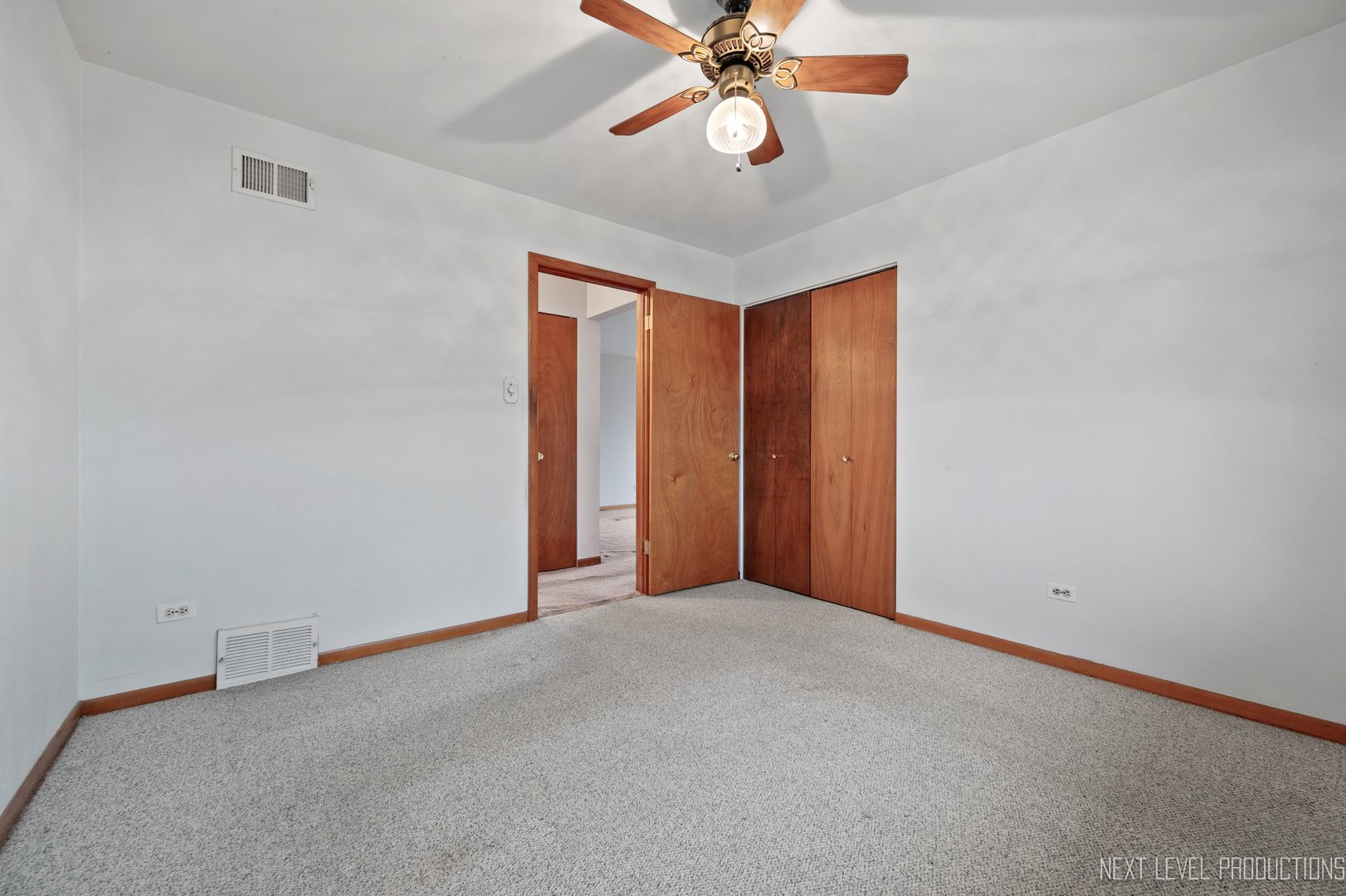 10336 Leslie Lane Chicago Ridge, IL 60415 - Photo 15 of 28 an empty room with a chandelier fan and a ceiling fan