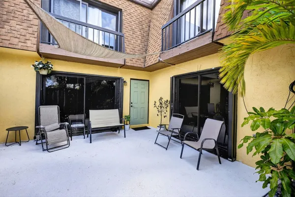 a building outdoor space with patio furniture and potted plants