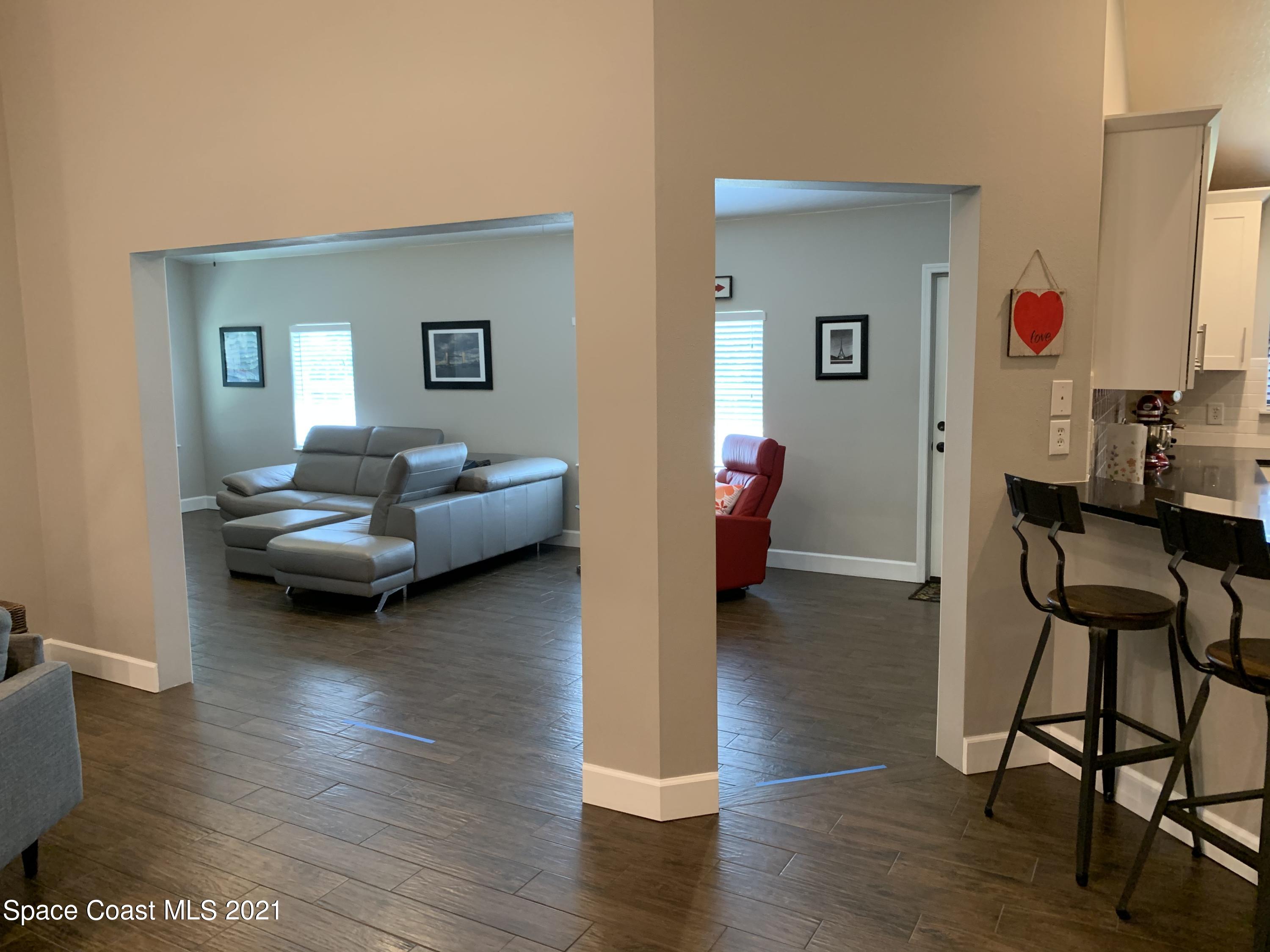 3485 Grant Line Road Mims, FL 32754 - Photo 14 of 40 a living room with furniture and a wooden floor