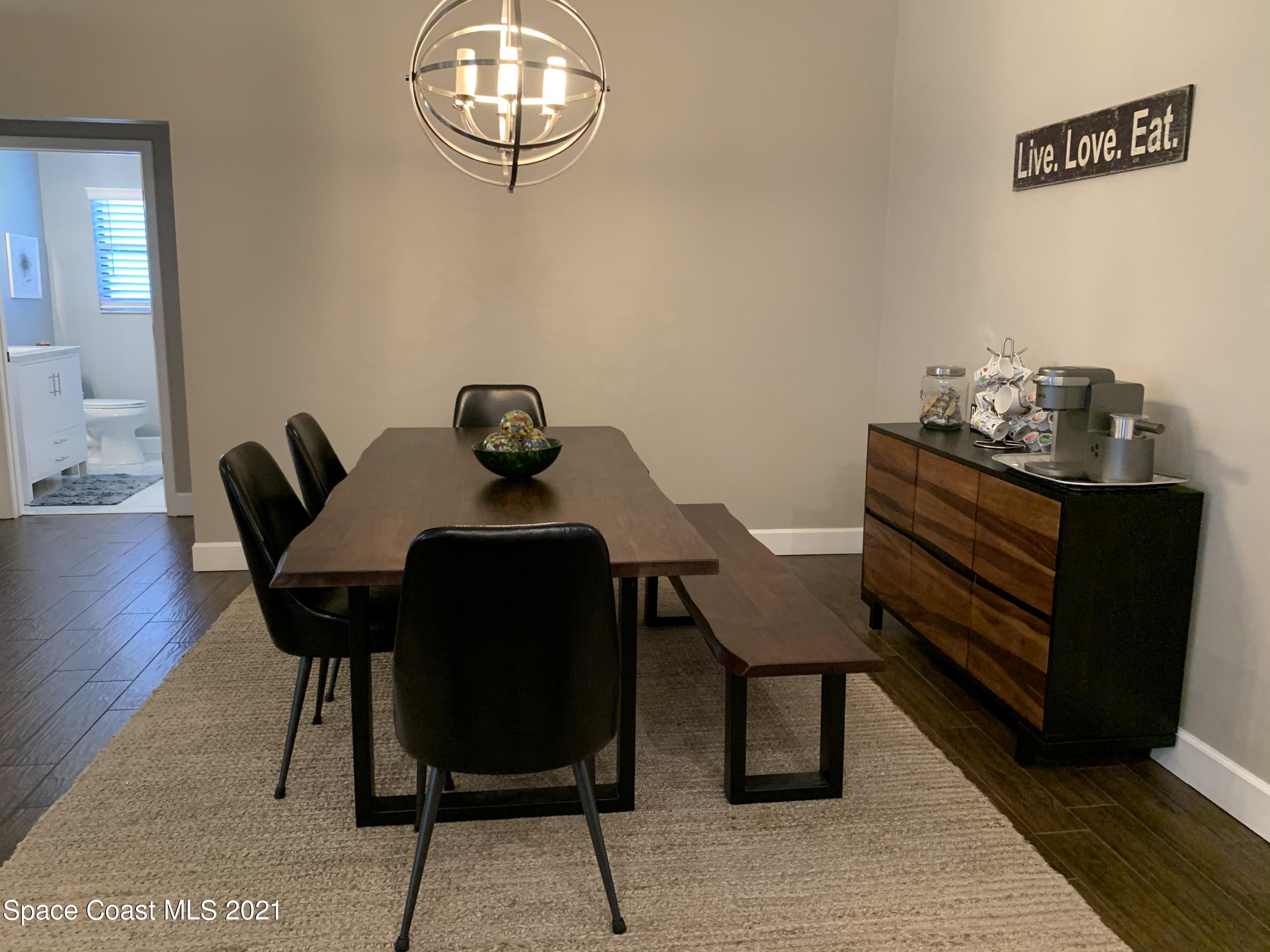 3485 Grant Line Road Mims, FL 32754 - Photo 8 of 40 a view of a dining room with furniture and wooden floor