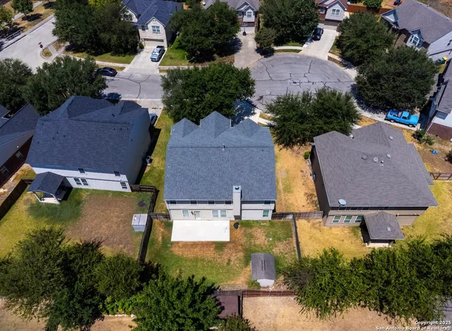 an aerial view of houses with yard