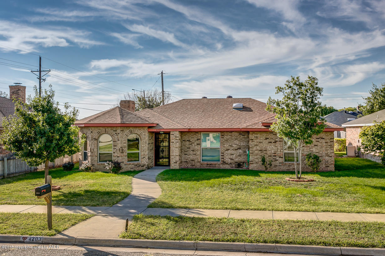 4203 Rondo Avenue Amarillo, TX 79110 - Photo 1 of 21 a front view of a house with a yard
