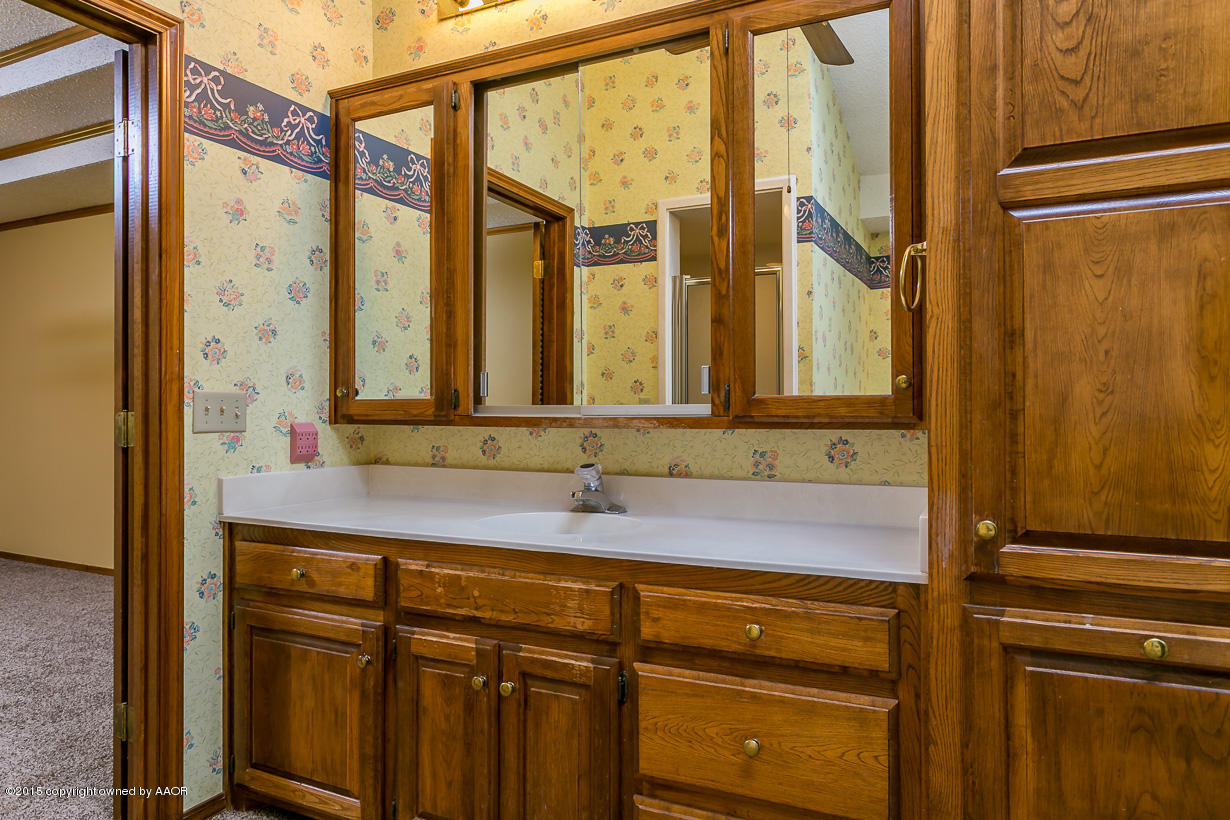 4203 Rondo Avenue Amarillo, TX 79110 - Photo 11 of 21 a bathroom with a sink and a mirror