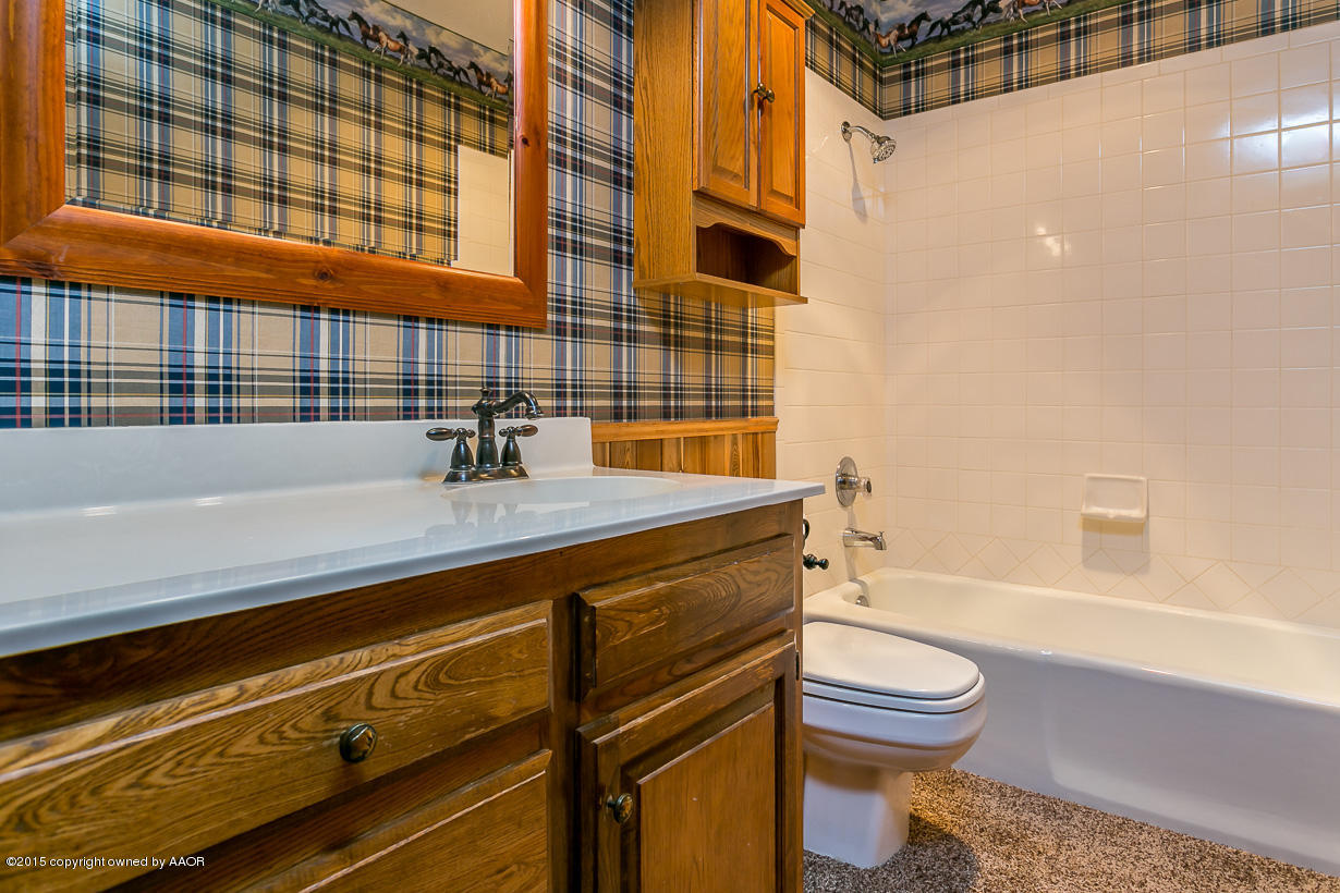 4203 Rondo Avenue Amarillo, TX 79110 - Photo 15 of 21 a bathroom with a sink a toilet and shower