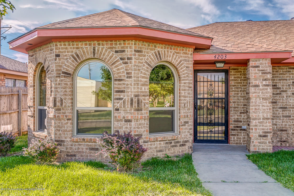 4203 Rondo Avenue Amarillo, TX 79110 - Photo 2 of 21 a front view of a house with garden