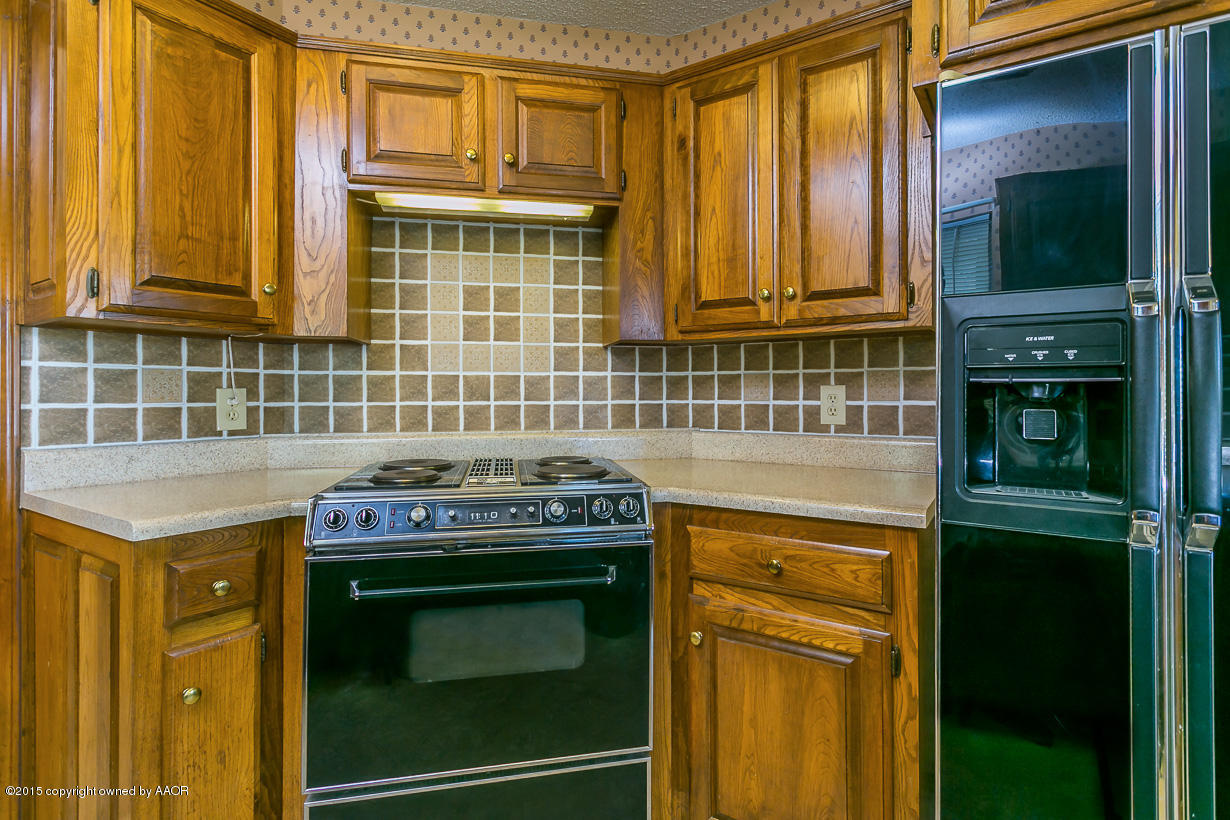 4203 Rondo Avenue Amarillo, TX 79110 - Photo 6 of 21 a kitchen with granite countertop a stove and a cabinet