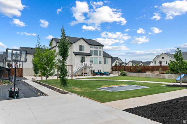 500 North 516th Street West, Unit 19 Mapleton, UT 84664 - Photo 35 of 41 The backyard features a basketball court, swing set, and an in-ground trampoline with a French drain system for consistent drainage.