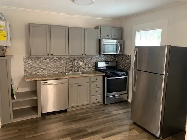 a kitchen with a refrigerator stove and microwave