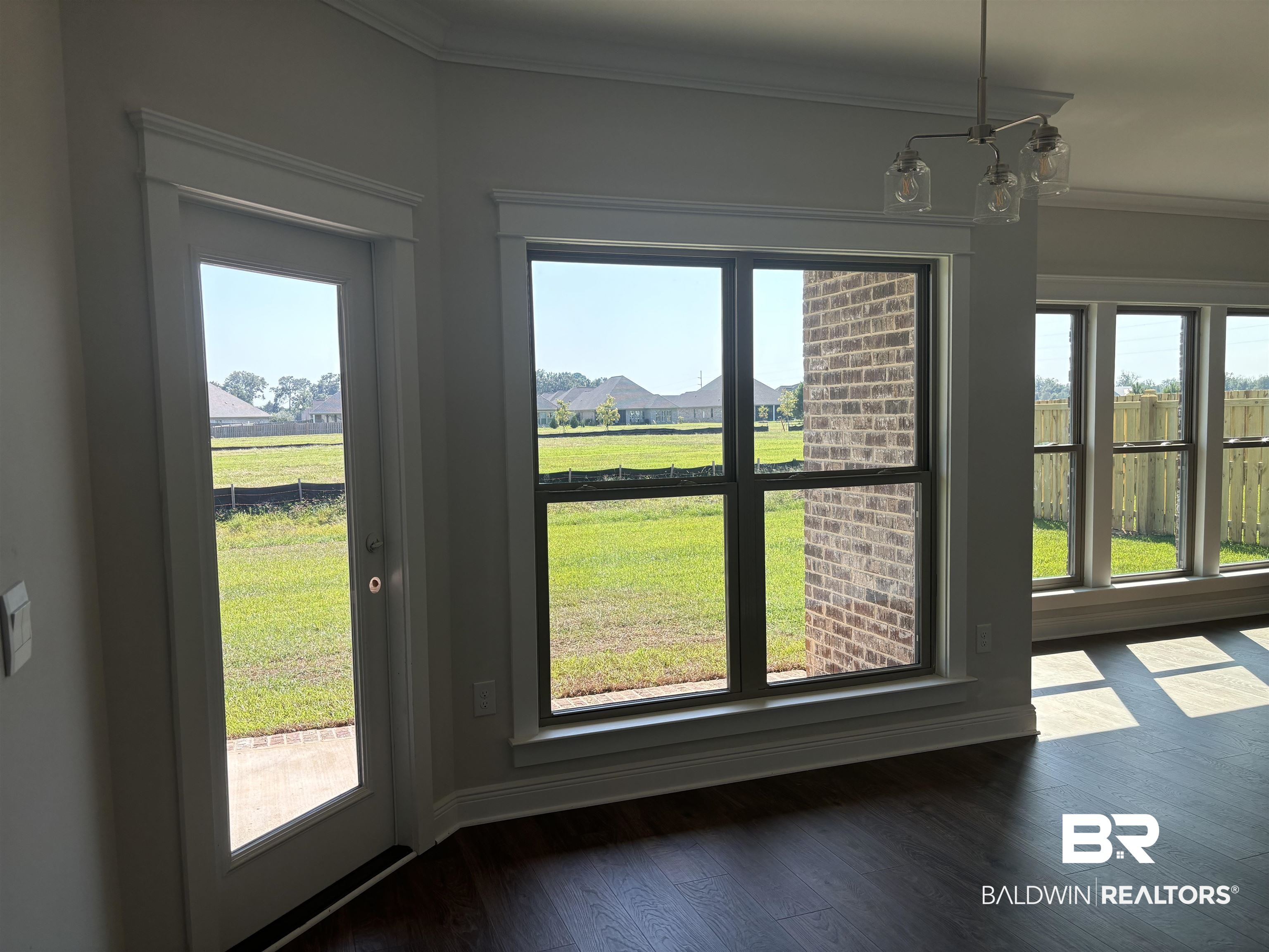 388 Garrison Boulevard Fairhope, AL 36532 - Photo 10 of 34 Interior space featuring a notable chandelier, ornamental molding, and hardwood / wood-style flooring