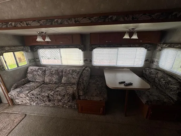 a kitchen with stainless steel appliances granite countertop a refrigerator a stove a sink and a microwave