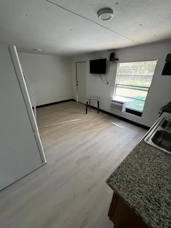 a bathroom with a sink and mirror with toilet