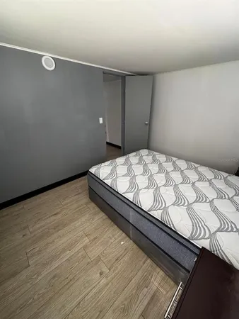 a bed sitting in a bedroom next to a window