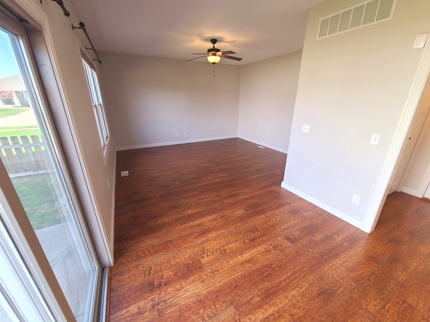 790 Muirfield Circle Eldridge, IA 52748 - Photo 12 of 36 a view of a hallway with wooden floor and a ceiling fan
