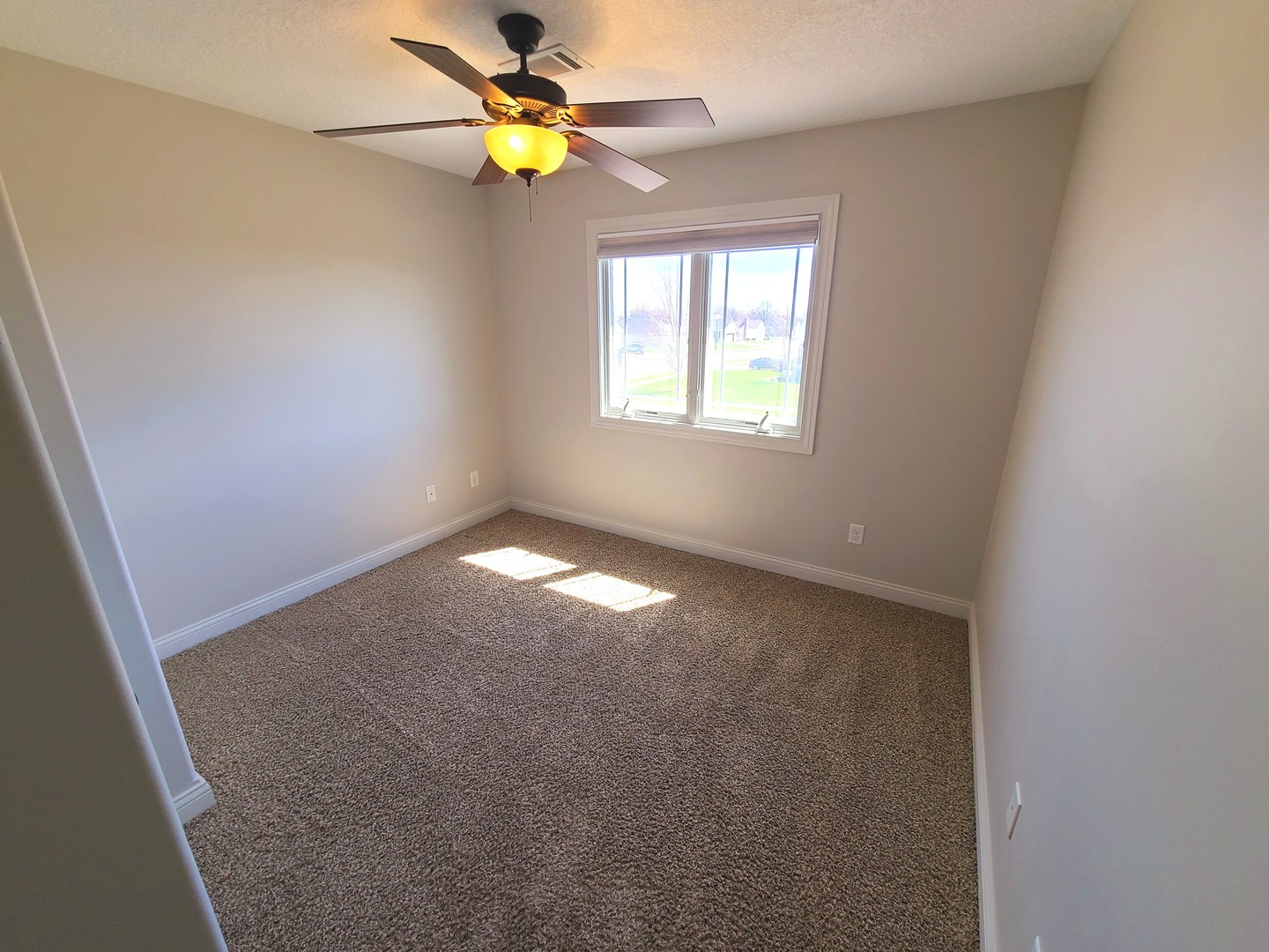 790 Muirfield Circle Eldridge, IA 52748 - Photo 23 of 36 an empty room with windows and fan