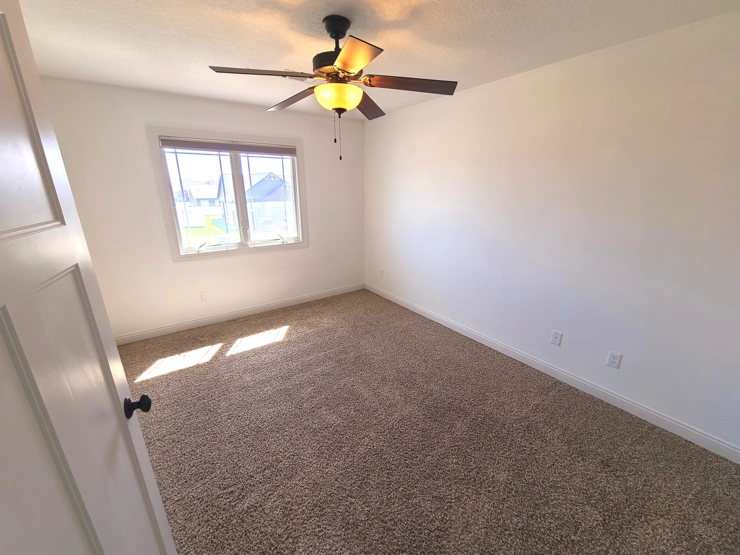 790 Muirfield Circle Eldridge, IA 52748 - Photo 25 of 36 an empty room with a window and a fan