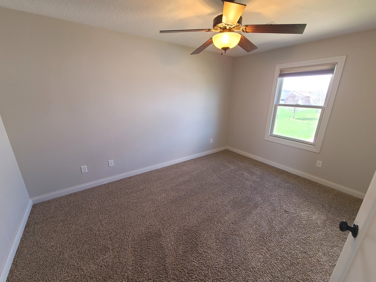 790 Muirfield Circle Eldridge, IA 52748 - Photo 27 of 36 an empty room with a window and a fan
