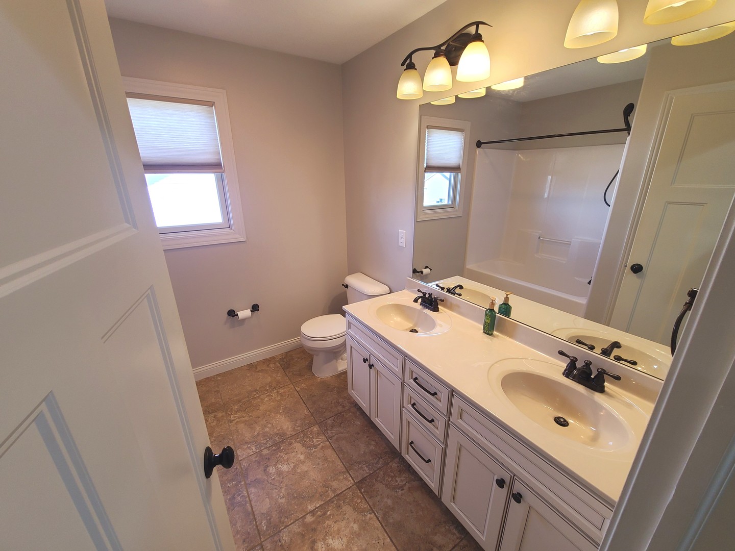 790 Muirfield Circle Eldridge, IA 52748 - Photo 28 of 36 a spacious bathroom with a double vanity sink mirror and a toilet