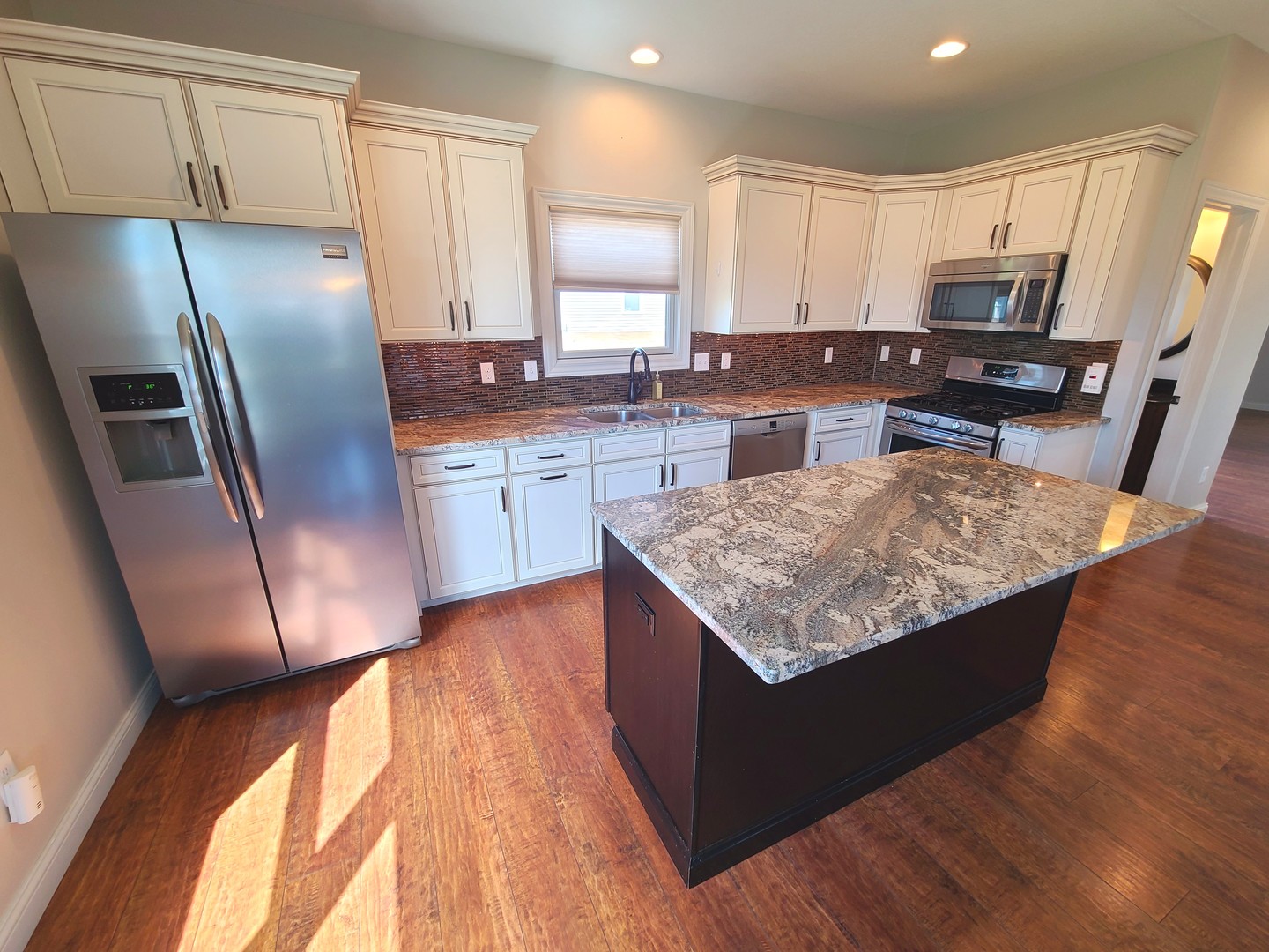 790 Muirfield Circle Eldridge, IA 52748 - Photo 9 of 36 a kitchen with stainless steel appliances granite countertop a refrigerator a sink a stove a microwave and island
