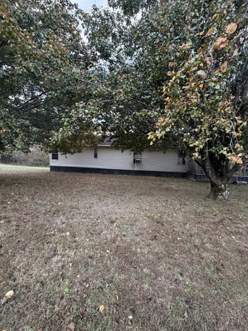 a view of a barn in the middle of a yard