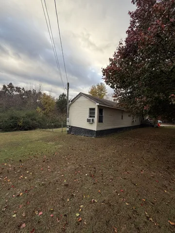 a view of a house with truck parked on the road